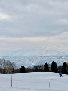 snowboarder walking back up to the top of the halfpipe