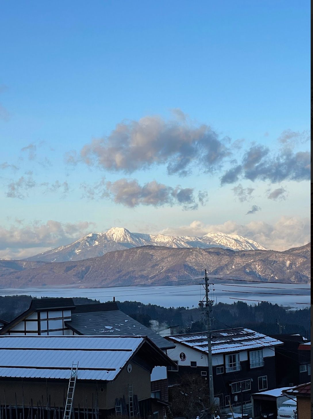Kaiya lodge with mountains in the background over nozawa