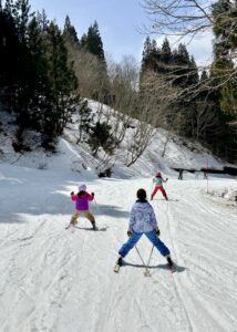 kids skiing down forest course